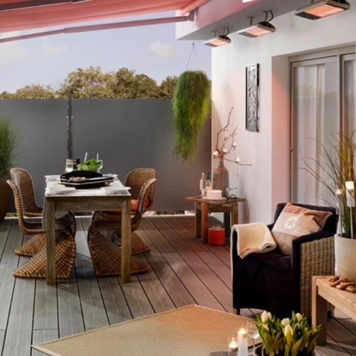 Stylish outdoor patio with a dining table set for a meal, featuring wicker chairs, modern decor, and greenery, perfect for entertaining and relaxation.