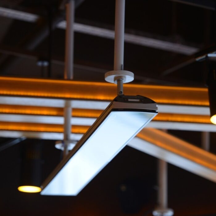Modern LED ceiling light fixture illuminating a contemporary interior space with warm accent lighting.