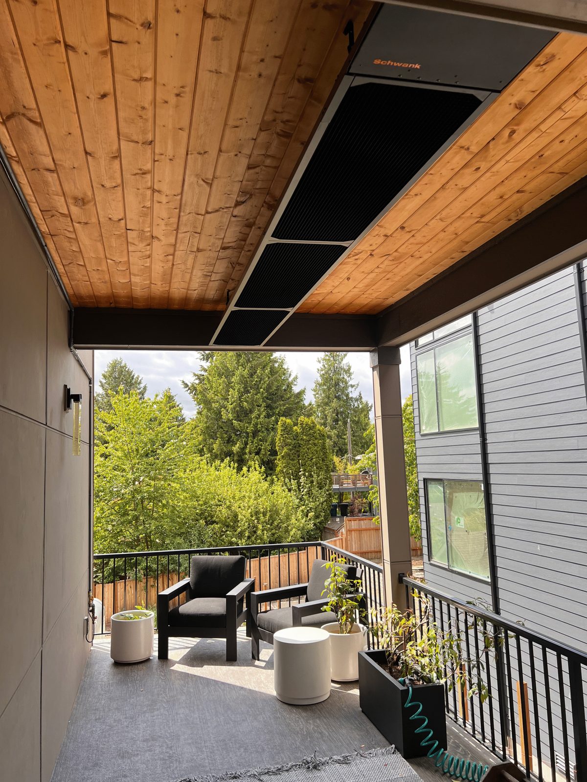 phantomSchwank black tube heater recessed into a cedar covered deck ceiling at a home