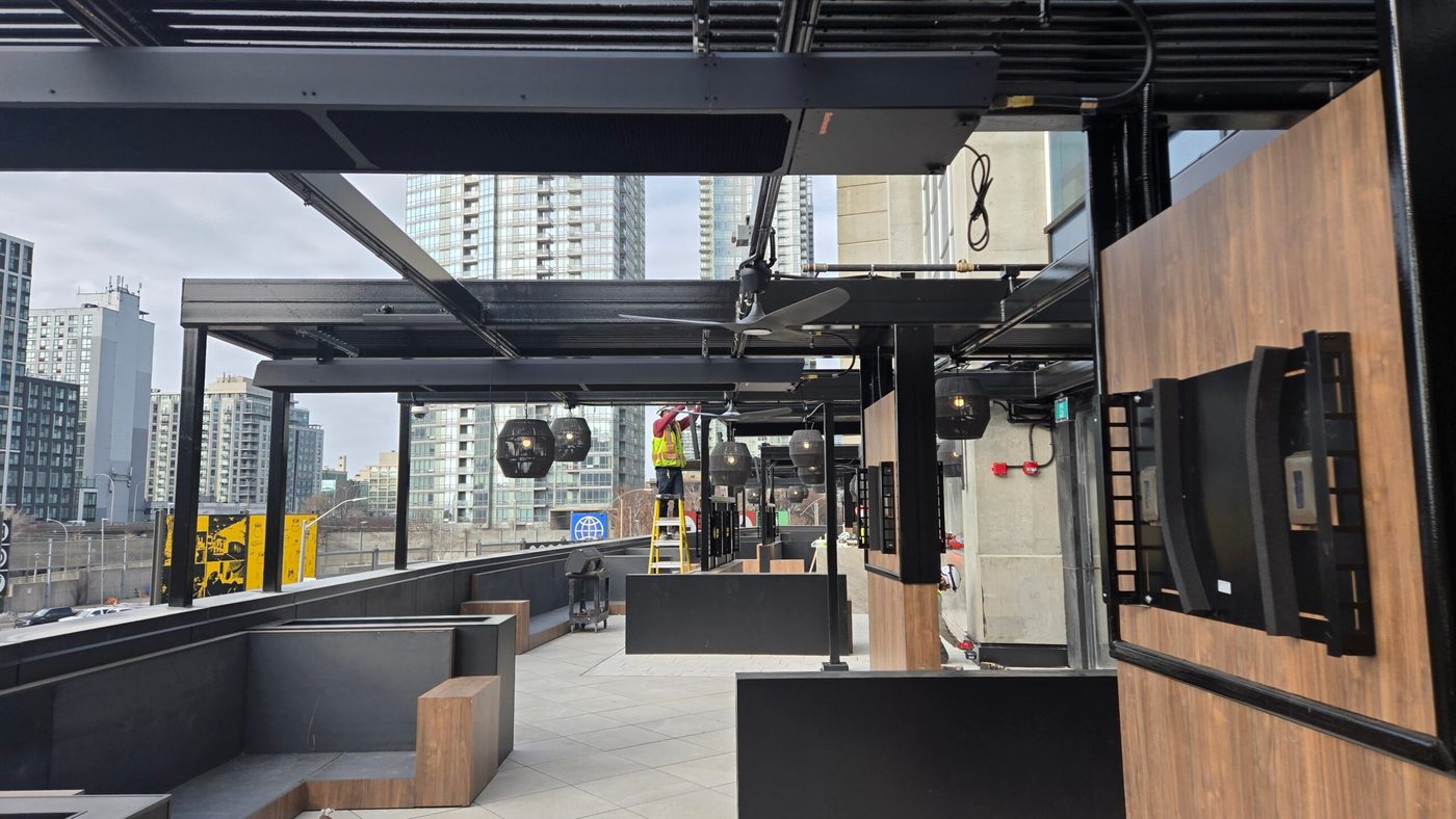 phantomSchwank tube heaters being installed on a rooftop patio near Rogers Centre in downtown Toronto